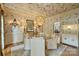 Elegant dining room with fish wallpaper and a stylish light fixture above the round table at 12028 Royal Lytham Ct, Charlotte, NC 28277