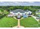Expansive aerial view of a grand clubhouse with manicured lawns and outdoor terraces perfect for entertaining at 12028 Royal Lytham Ct, Charlotte, NC 28277