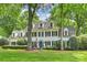 Beautiful traditional-style home featuring dormer windows, black shutters, and a well-manicured front lawn at 12028 Royal Lytham Ct, Charlotte, NC 28277