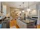 Well-equipped kitchen with island and bar seating which opens to a comfortable living area at 12028 Royal Lytham Ct, Charlotte, NC 28277
