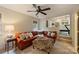 Cozy living room with an orange sectional and an ottoman, adjacent to a home gym at 12028 Royal Lytham Ct, Charlotte, NC 28277