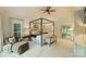 Serene main bedroom with a four-poster bed, neutral colors, and ample natural light at 12028 Royal Lytham Ct, Charlotte, NC 28277