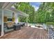 Stylish outdoor deck with comfortable seating and views of the pool and lush backyard at 12028 Royal Lytham Ct, Charlotte, NC 28277