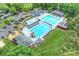 Stunning aerial view of community pools with lounge areas, a play area, and ample parking at 12028 Royal Lytham Ct, Charlotte, NC 28277