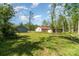 Backyard of a home with lush greenery, mature trees, and outbuildings at 1263 Crawford Rd, Rock Hill, SC 29730