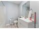 Cozy bathroom featuring a shower with plastic curtain, toilet, and vanity with white cabinets at 1263 Crawford Rd, Rock Hill, SC 29730