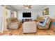 Cozy living room featuring plush leather seating, wood laminate flooring and a ceiling fan at 1263 Crawford Rd, Rock Hill, SC 29730