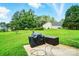 Large grassy backyard with patio area and privacy from mature trees at 12803 Matisse Ln, Charlotte, NC 28215