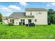 Expansive backyard featuring a well-maintained lawn, patio, and the rear facade of the house at 12803 Matisse Ln, Charlotte, NC 28215