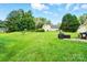 Spacious backyard with lush lawn and mature trees offering outdoor space at 12803 Matisse Ln, Charlotte, NC 28215
