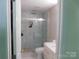 Bright bathroom features a glass shower with a rain shower head and stylish fixtures at 12803 Matisse Ln, Charlotte, NC 28215