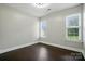 Clean bedroom with wood floors, neutral paint, and bright windows at 12803 Matisse Ln, Charlotte, NC 28215