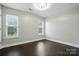 Empty bedroom featuring wood floors, white trim, and bright natural light at 12803 Matisse Ln, Charlotte, NC 28215