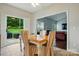 Eat-in kitchen with a dining table next to a sliding glass door and view to the backyard at 12803 Matisse Ln, Charlotte, NC 28215