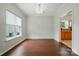 Hardwood-floor dining room with a window and access to the kitchen at 12803 Matisse Ln, Charlotte, NC 28215