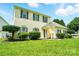 Inviting two-story home featuring a well-maintained lawn and inviting entrance at 12803 Matisse Ln, Charlotte, NC 28215