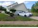 View of home with driveway and manicured landscaping at 12803 Matisse Ln, Charlotte, NC 28215