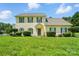 Charming two-story home featuring a well-manicured lawn, symmetrical design, and pleasant curb appeal at 12803 Matisse Ln, Charlotte, NC 28215