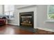 Close-up of a classic fireplace with elegant mantel and hardwood flooring at 12803 Matisse Ln, Charlotte, NC 28215