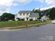 Charming two-story home with a well-maintained lawn and mature trees at 12803 Matisse Ln, Charlotte, NC 28215