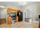 View of the kitchen with wood cabinets, stainless steel appliances, and tiled floors at 12803 Matisse Ln, Charlotte, NC 28215