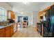 Bright kitchen boasts wood cabinets, a tile backsplash, and stainless steel appliances at 12803 Matisse Ln, Charlotte, NC 28215
