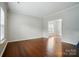 Open living room with hardwood floors and two windows at 12803 Matisse Ln, Charlotte, NC 28215