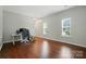 Living room area with desk, hardwood floors, and natural light at 12803 Matisse Ln, Charlotte, NC 28215