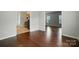 Living room with hardwood floors, light gray walls, and access to the kitchen at 12803 Matisse Ln, Charlotte, NC 28215