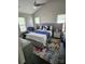 Cozy main bedroom boasts two windows and a plush bed with stylish rug and decor at 12803 Matisse Ln, Charlotte, NC 28215