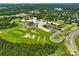 Aerial view of school complex with playground, sports fields, and surrounding neighborhood and trees at 1287 Fishing Creek Rd, Lake Wylie, SC 29710