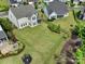 A spacious backyard with lush green grass, landscaping, trampoline, and a cozy fire pit area at 1287 Fishing Creek Rd, Lake Wylie, SC 29710