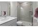 A modern bathroom featuring a glass-enclosed shower, a sleek vanity, and neutral tile at 1287 Fishing Creek Rd, Lake Wylie, SC 29710