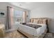 A cozy bedroom with a plush bed, large windows, neutral tones, and stylish decor at 1287 Fishing Creek Rd, Lake Wylie, SC 29710