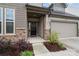 Welcoming front entrance with a black front door, stone accents, and a well-kept lawn at 1287 Fishing Creek Rd, Lake Wylie, SC 29710