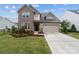 Charming two-story home with stone accents, landscaped yard, a two-car garage, and a welcoming front entrance at 1287 Fishing Creek Rd, Lake Wylie, SC 29710