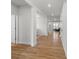 A bright hallway featuring wood floors, white walls, and an open floor plan leading to other rooms at 1287 Fishing Creek Rd, Lake Wylie, SC 29710