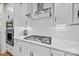 Close-up of the gourmet kitchen features stainless steel appliances and sleek white cabinets with a stylish backsplash at 1287 Fishing Creek Rd, Lake Wylie, SC 29710