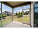 Screened-in porch with views of the backyard and neighboring houses, offering an outdoor living space at 1287 Fishing Creek Rd, Lake Wylie, SC 29710