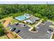 Aerial view of the community pool and clubhouse with lush landscaping and parking, for outdoor recreation at 1287 Fishing Creek Rd, Lake Wylie, SC 29710
