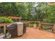 Spacious back deck with barbecue, room for potted plants, and wooden railings at 13312 Edgetree Dr, Pineville, NC 28134
