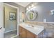 Well-lit bathroom featuring a vanity with a cultured marble countertop and decorative mirror at 13312 Edgetree Dr, Pineville, NC 28134