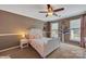 Inviting bedroom with a white bed frame, soft lighting, and two bright windows at 13312 Edgetree Dr, Pineville, NC 28134