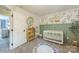 Charming Bedroom showcasing leafy wallpaper, olive green panelling, and alphabet rug at 13312 Edgetree Dr, Pineville, NC 28134
