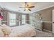 Sunny bedroom with modern crown moulding, a stylish dresser, and bright natural light at 13312 Edgetree Dr, Pineville, NC 28134
