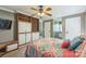 Bedroom features built-in shelves and cabinets, ceiling fan, and a colorful bedspread at 13312 Edgetree Dr, Pineville, NC 28134
