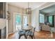 Cozy breakfast nook with rustic-style table, chairs, and access to outdoor deck at 13312 Edgetree Dr, Pineville, NC 28134