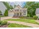 Charming two-story home featuring a welcoming front porch and manicured landscaping at 13312 Edgetree Dr, Pineville, NC 28134