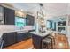 Modern kitchen boasts dark cabinets, granite counters, an island with seating, and stainless steel appliances at 13312 Edgetree Dr, Pineville, NC 28134