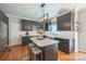 Modern kitchen features an island, granite countertops, and stainless steel appliances at 13312 Edgetree Dr, Pineville, NC 28134
